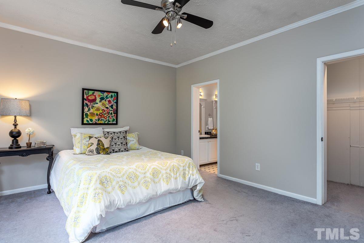 3882 Millard Whitley Road Chapel Hill, NC 27516 - Photo 10 of 20 a bedroom with a bed and a chandelier