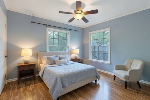 a bedroom with a bed and wooden floor