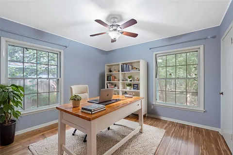 a living room with a bed and a window