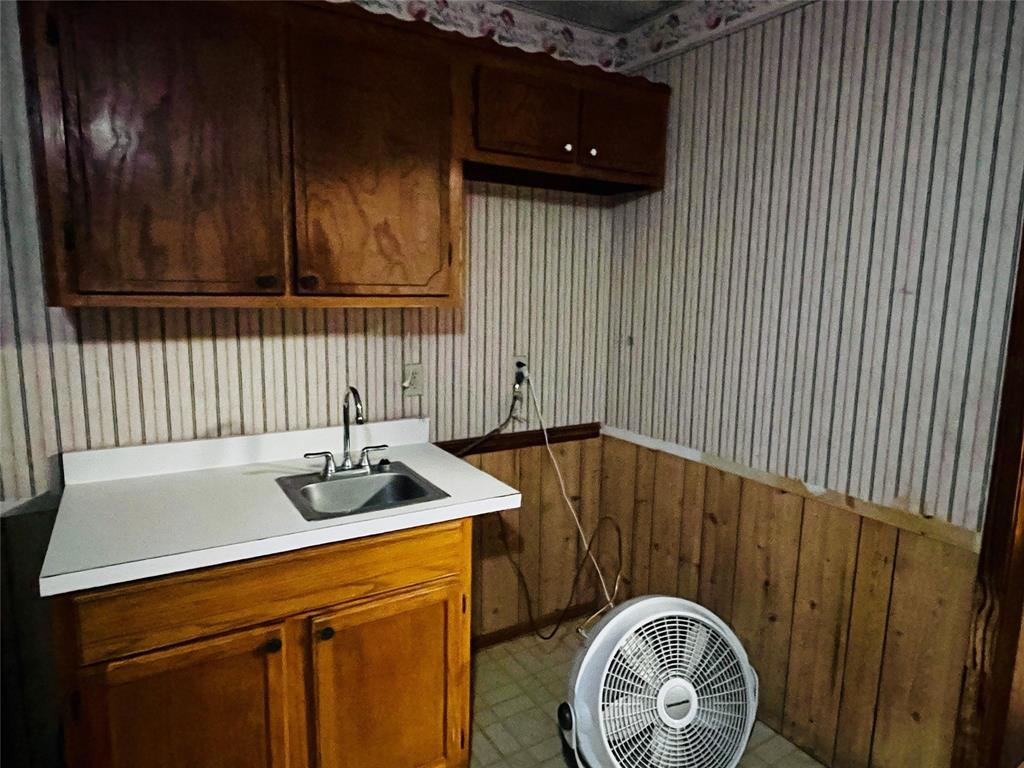 701 County Road 319 Early, TX 76802 - Photo 19 of 33 Laundry room featuring wooden walls and wallpapered walls