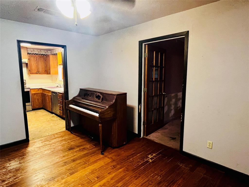 701 County Road 319 Early, TX 76802 - Photo 21 of 33 Hall featuring light wood-style flooring and a textured ceiling