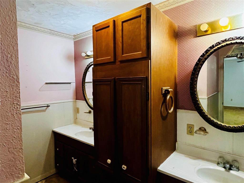 701 County Road 319 Early, TX 76802 - Photo 24 of 33 Half bathroom featuring vanity and ornamental molding
