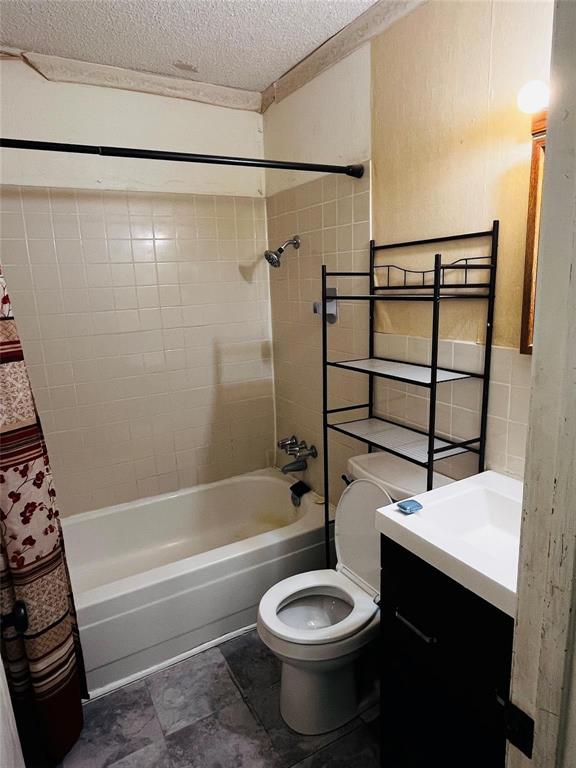 701 County Road 319 Early, TX 76802 - Photo 25 of 33 Full bathroom with shower / bath combination with curtain, vanity, and a textured ceiling