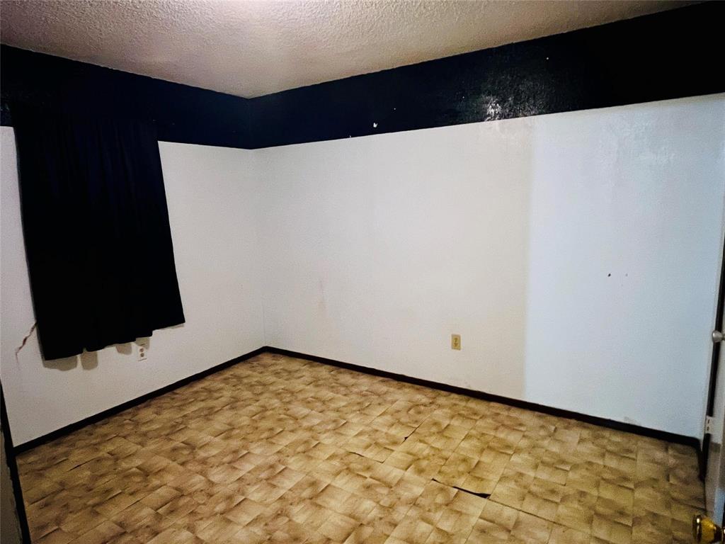 701 County Road 319 Early, TX 76802 - Photo 28 of 33 Spare room featuring a textured ceiling and baseboards