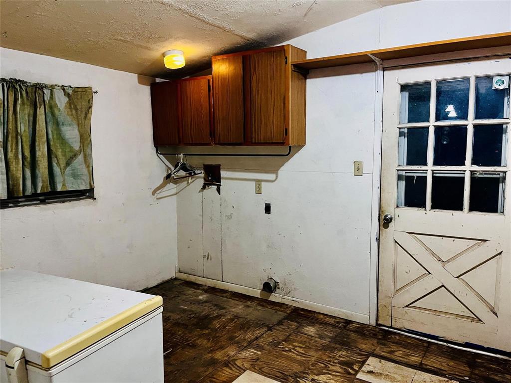 701 County Road 319 Early, TX 76802 - Photo 29 of 33 Washroom with a textured ceiling and cabinet space
