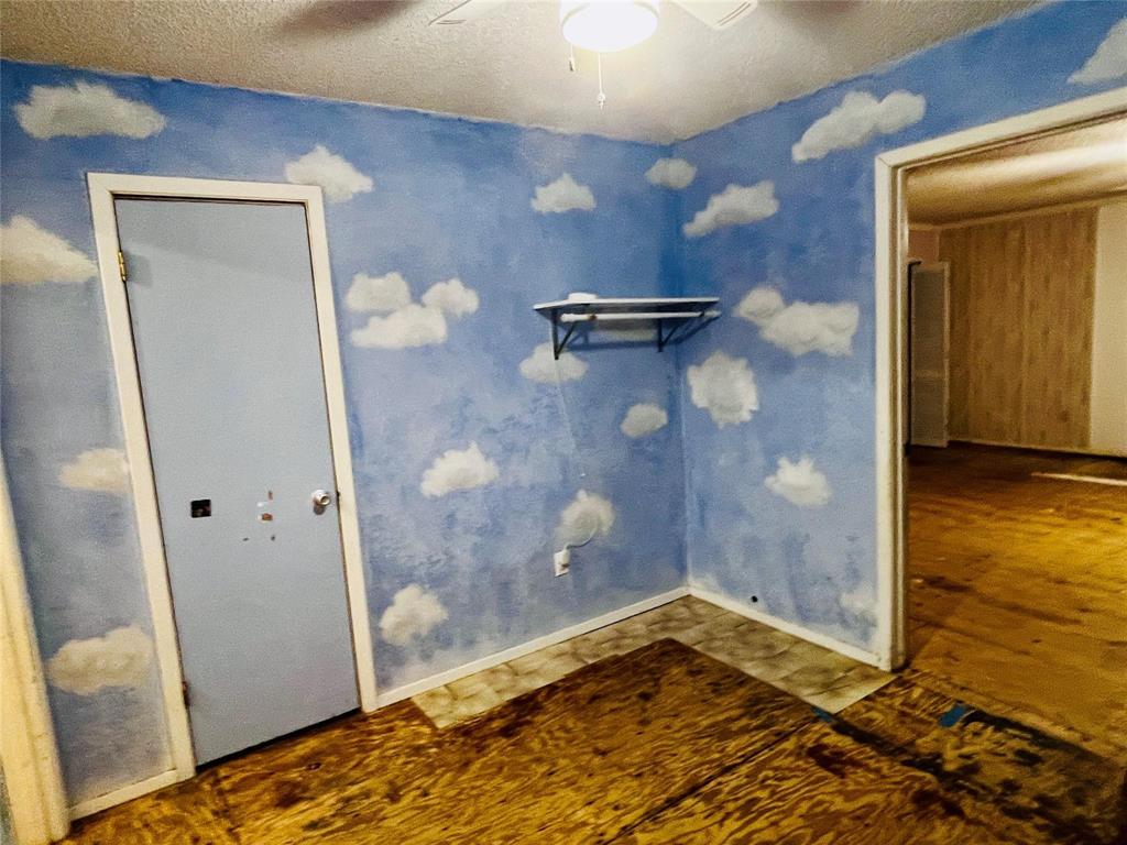 701 County Road 319 Early, TX 76802 - Photo 31 of 33 Unfurnished bedroom with a textured ceiling and a ceiling fan