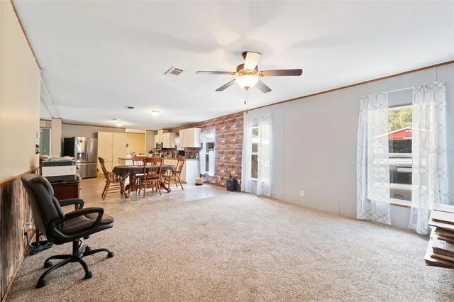 a bedroom with a bed and dresser with mirror