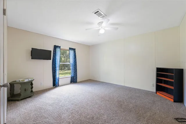 a bathroom with a granite countertop toilet sink and mirror