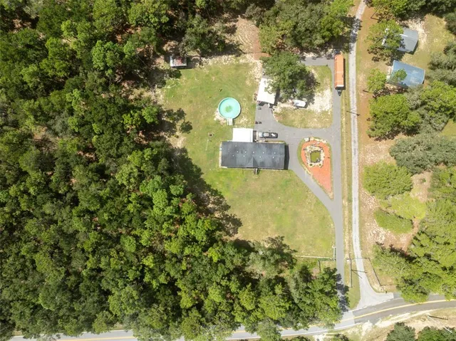 a view of a house with swimming pool and a yard