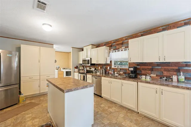 a kitchen with counter top space and refrigerator