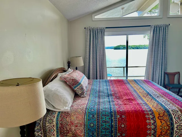 a view of a room with wooden floor and windows