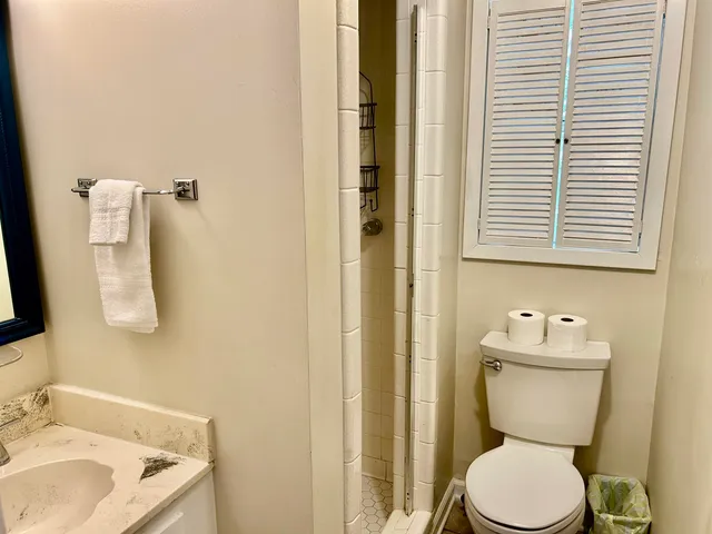 a large bed sitting in a bedroom next to a window