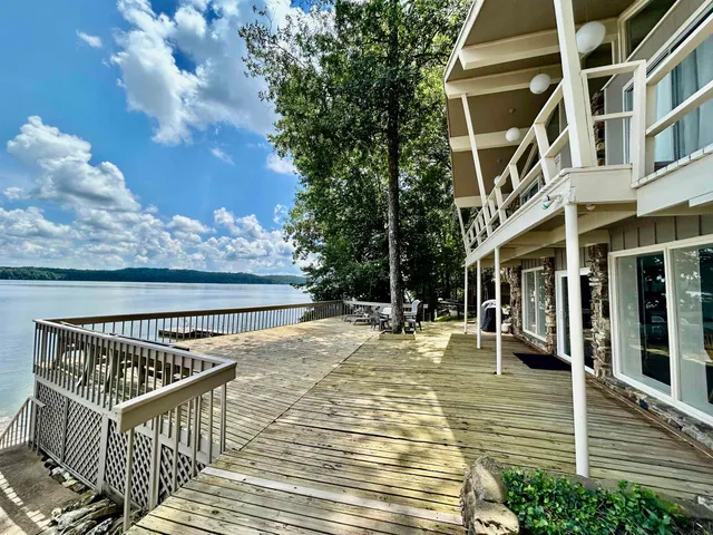 a view of a house with a yard and lake view