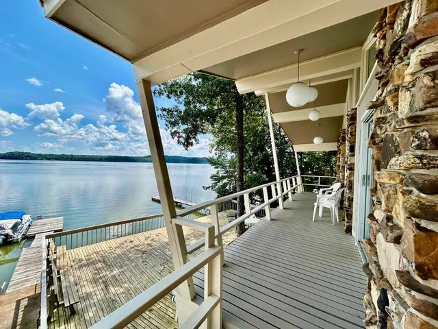 a view of a balcony with chairs and wooden floor