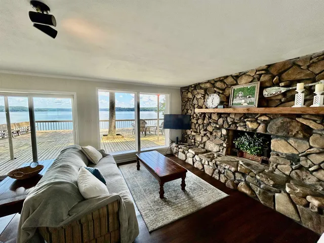 a living room with furniture and a floor to ceiling window