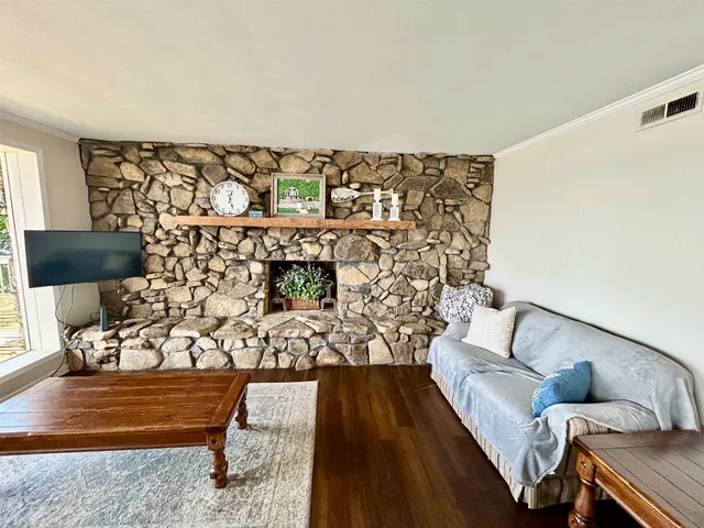 a view of living room filled with furniture and a rug