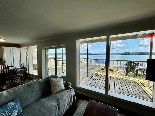 a living room with furniture and floor to ceiling windows