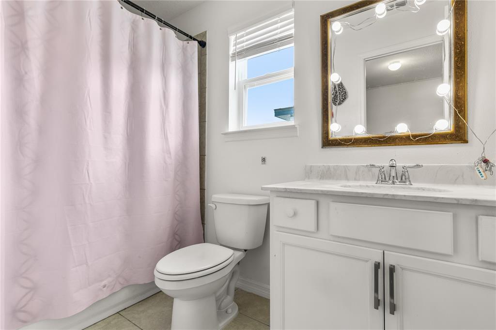 5637 Beggs Road St. Cloud, FL 34771 - Photo 24 of 35 a bathroom with a sink vanity mirror and toilet