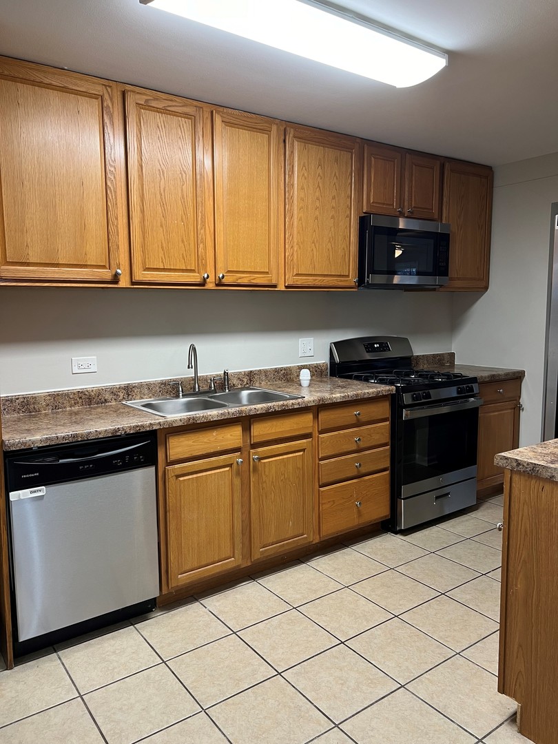 2300 Central Road Rolling Meadows, IL 60008 - Photo 5 of 14 a kitchen with granite countertop cabinets stainless steel appliances and a sink