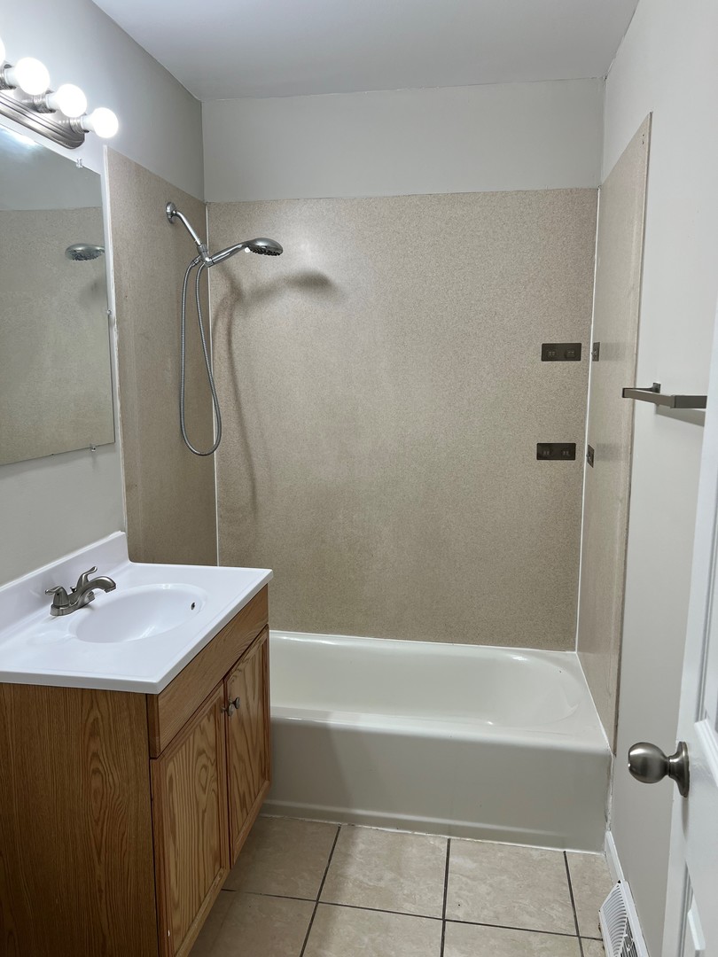 2300 Central Road Rolling Meadows, IL 60008 - Photo 7 of 14 a bathroom with a sink a shower and a mirror