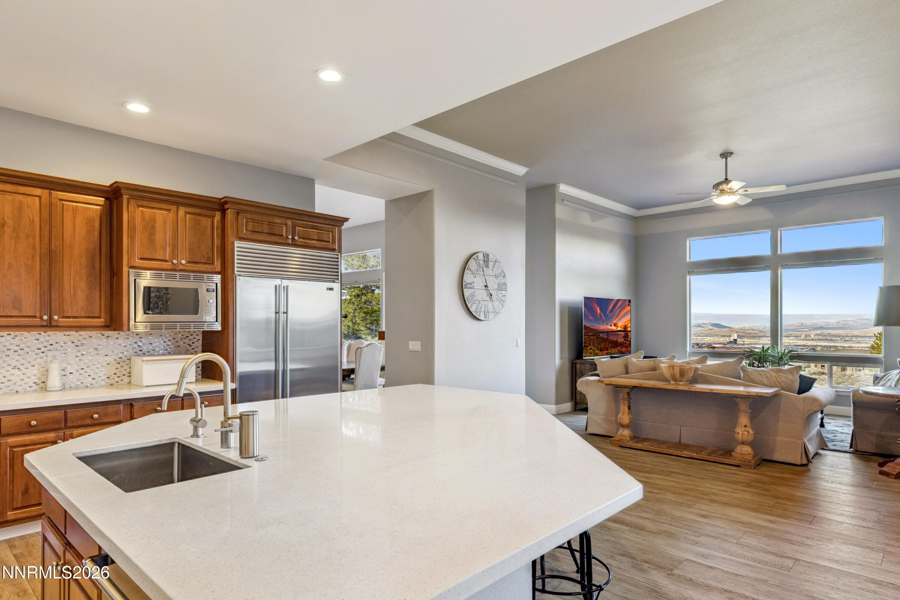 3670 Spirit Bluff Court Reno, NV 89511 - Photo 16 of 54 a kitchen with kitchen island a large counter top space appliances and a sink