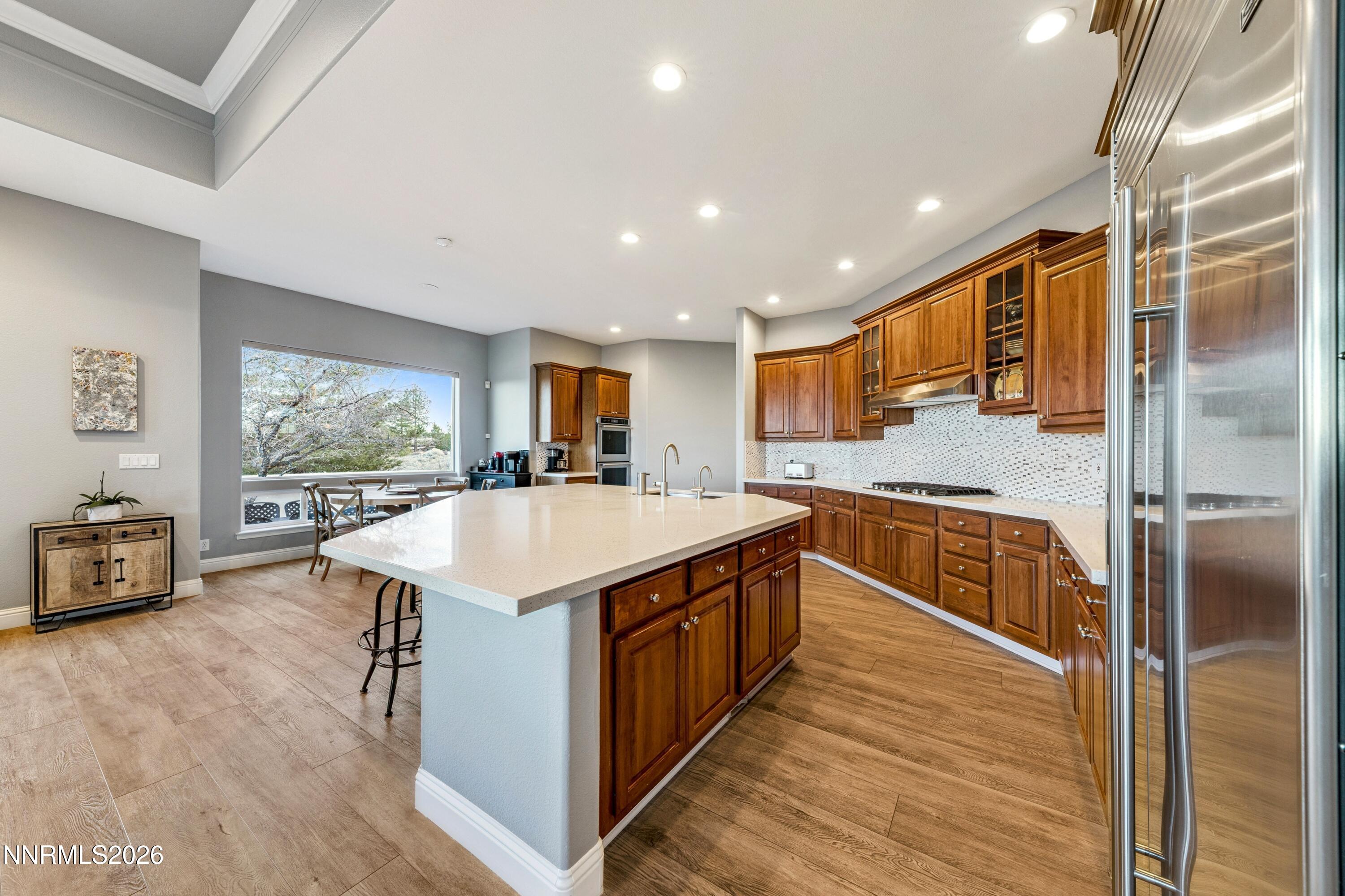 3670 Spirit Bluff Court Reno, NV 89511 - Photo 17 of 54 a large kitchen with stainless steel appliances granite countertop a large counter top a stove and a sink