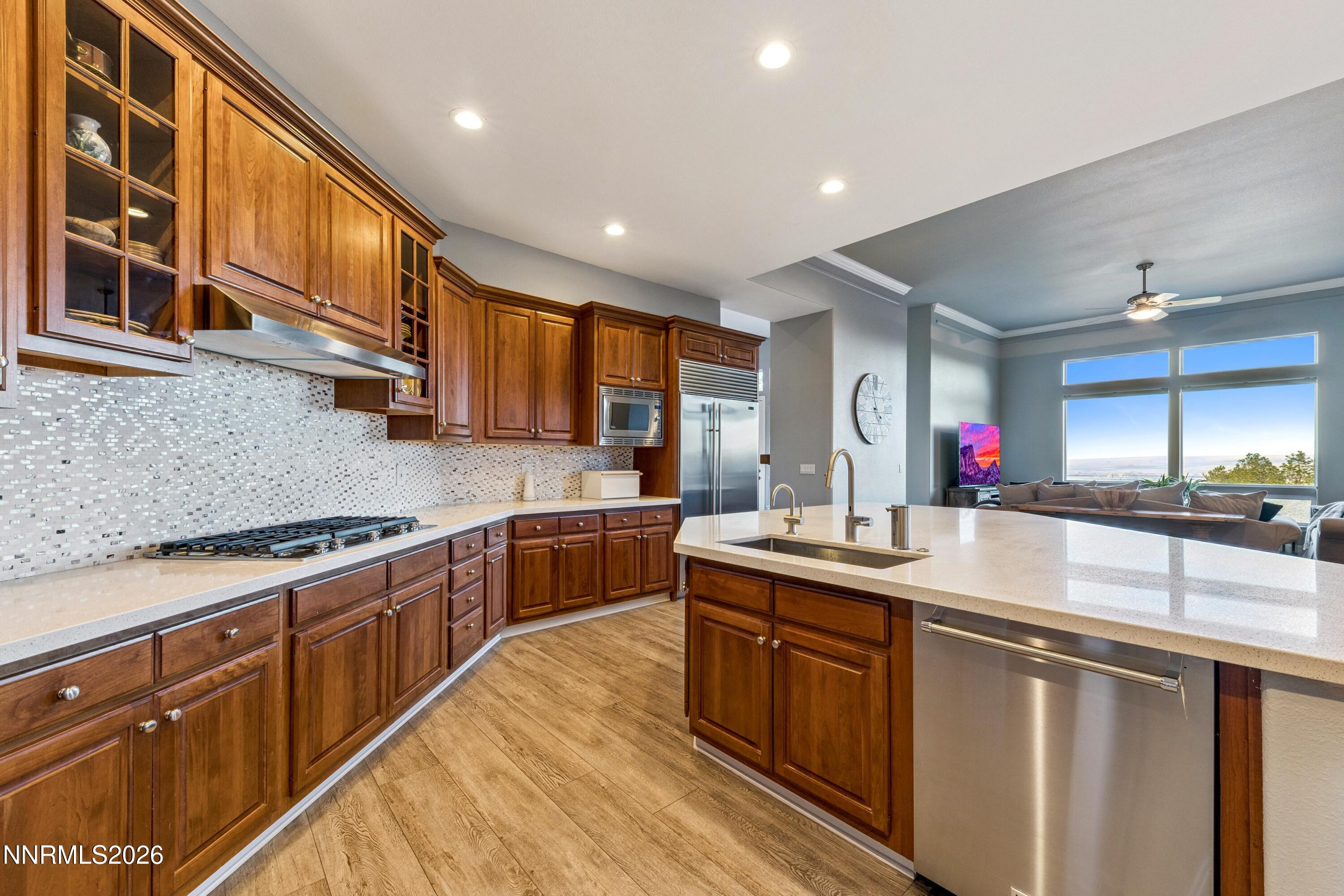 3670 Spirit Bluff Court Reno, NV 89511 - Photo 19 of 54 a kitchen with stainless steel appliances granite countertop sink stove and cabinets