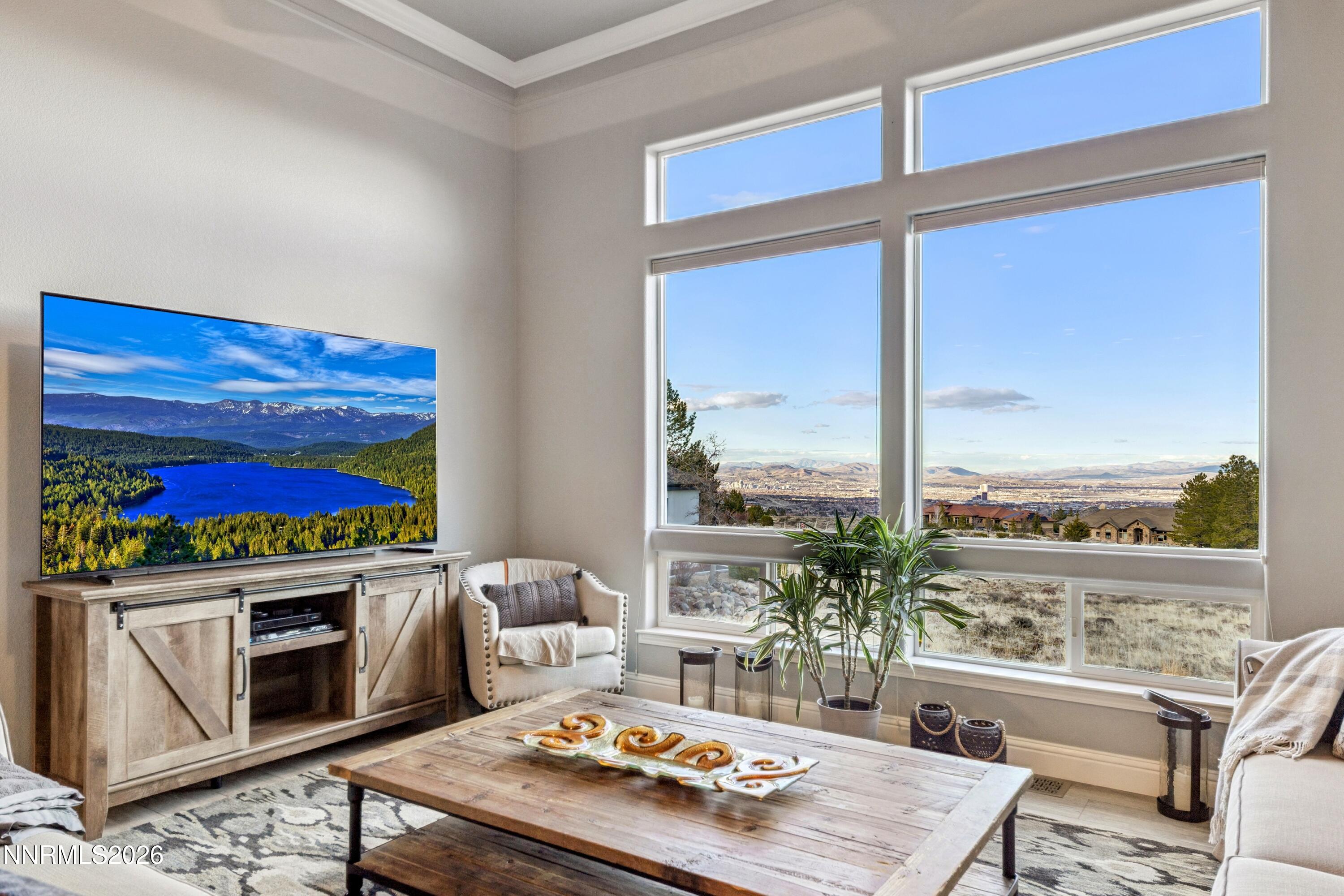 3670 Spirit Bluff Court Reno, NV 89511 - Photo 22 of 54 a living room with furniture a flat screen tv and a floor to ceiling window