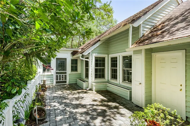 a view of house with backyard and outdoor seating