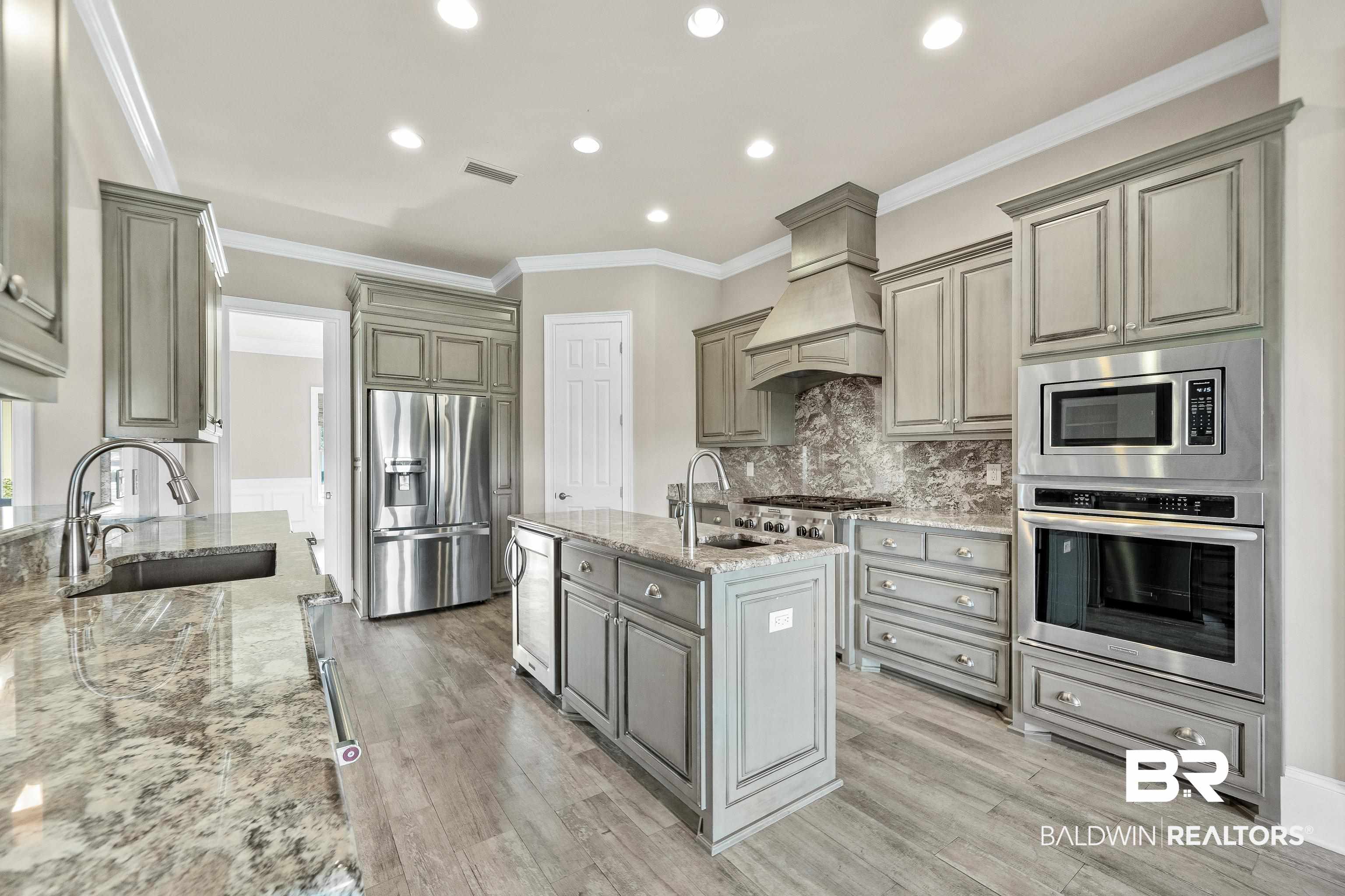 17663 Burwick Loop Fairhope, AL 36532 - Photo 15 of 41 Kitchen featuring light hardwood / wood-style floors, sink, custom exhaust hood, and stainless steel appliances