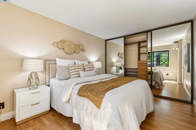 a bedroom with a bed and wooden floor