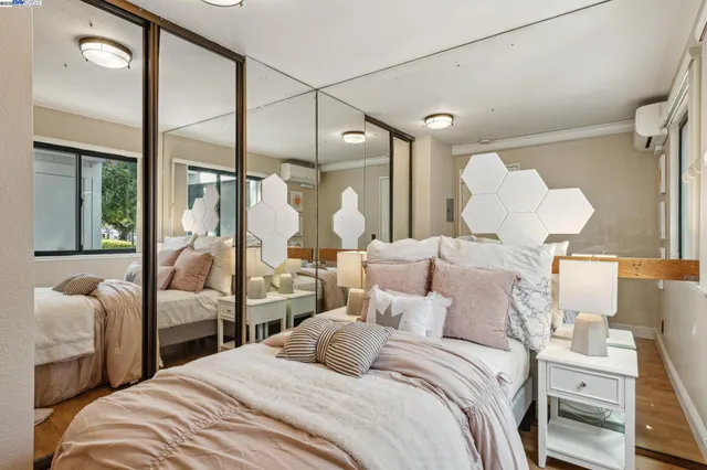 a bedroom with a bed window and couch