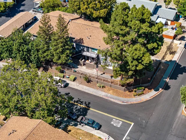 an aerial view of a house with a yard basket ball court and outdoor seating