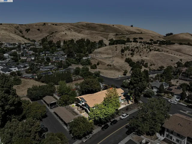 an aerial view of houses with a yard