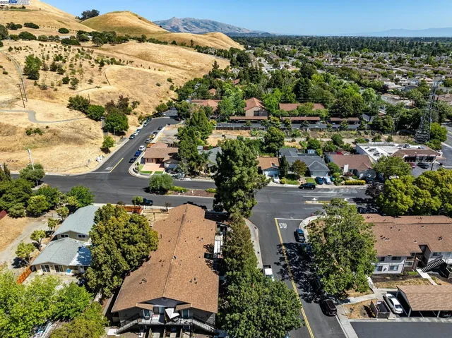 an aerial view of a house with a yard
