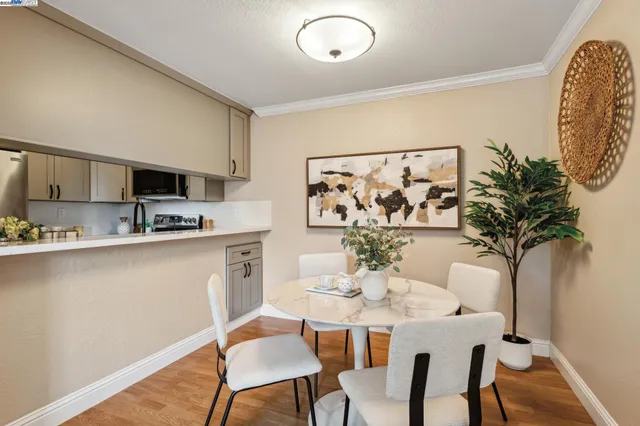 a view of a dining room with furniture and wooden floor