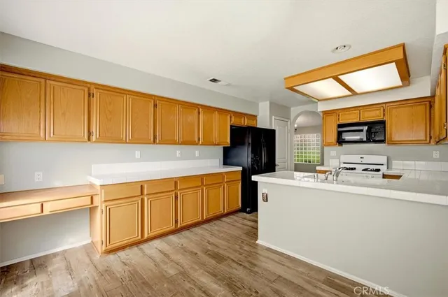 a kitchen with stainless steel appliances a sink stove and a refrigerator