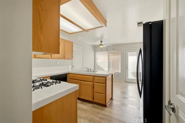 a kitchen with a sink a stove and cabinets