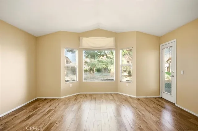 a bedroom with a bed and a flat tv screen on dresser