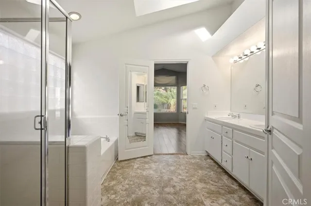a bathroom with double sink and a mirror