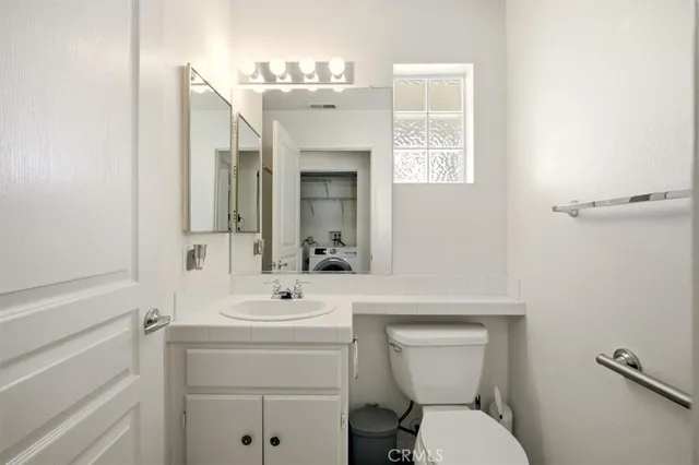 a view of an empty room with closet and a window