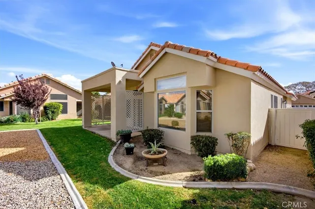 a front view of house with yard and outdoor seating