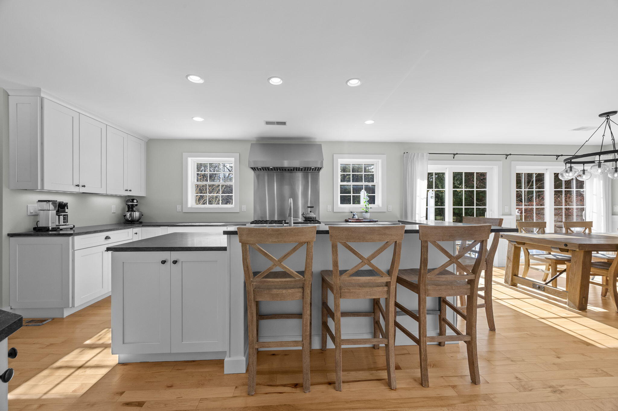 174 Cross Neck Road Marion, MA 02738 - Photo 12 of 41 a kitchen with stainless steel appliances kitchen island granite countertop a table chairs sink and cabinets