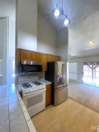 a kitchen with stainless steel appliances a stove a sink and a refrigerator