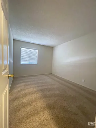 an empty room with a empty space and windows