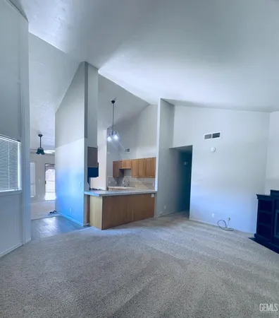 a open kitchen with a sink and dishwasher a stove top oven with wooden floor