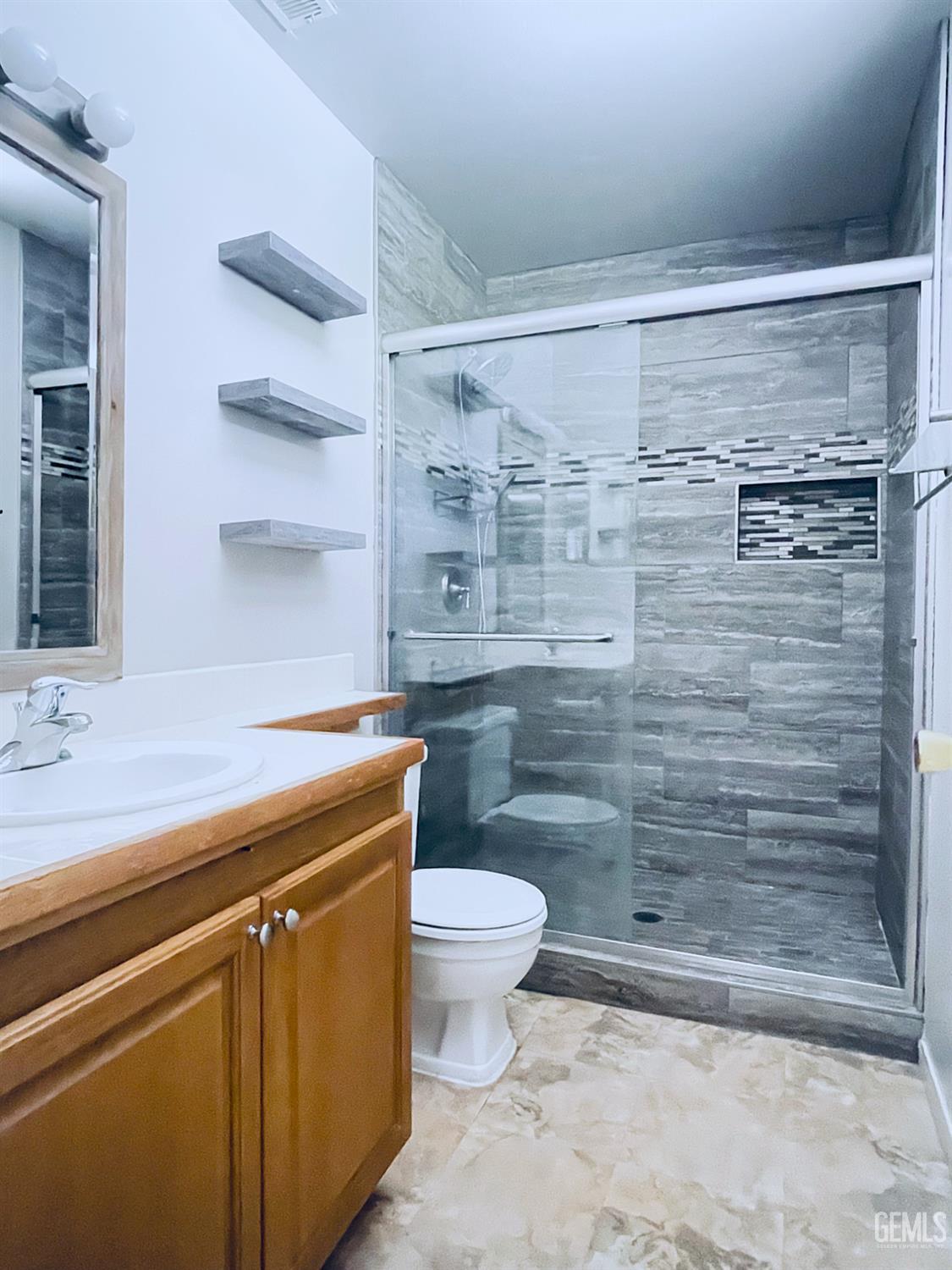 Undisclosed Address Tehachapi, CA 93561 - Photo 21 of 29 a bathroom with a granite countertop toilet and a sink