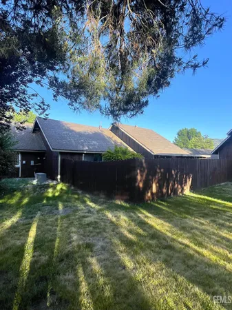 a view of a couches in front of house and swimming pool