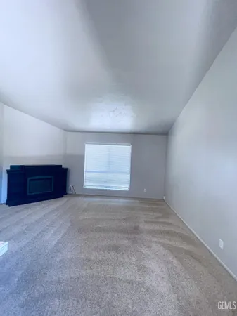 a view of an empty room and kitchen space