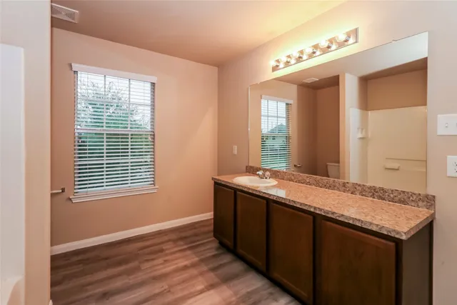 a room with a sink and a mirror